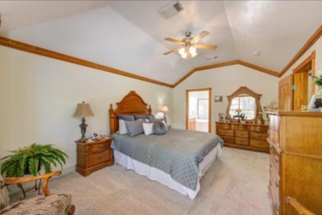 bedroom featuring crown molding, visible vents, light colored carpet, and lofted ceiling