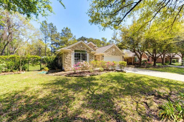 24501 Sable Creek Ct, Porter, TX 77365 - view of front facade with stone siding, concrete driveway, a chimney, and an attached garage