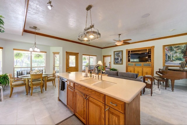 kitchen with light countertops, a ceiling fan, stainless steel dishwasher, pendant lighting, and a sink