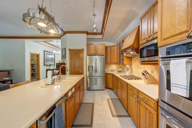 kitchen featuring brown cabinetry, ornamental molding, appliances with stainless steel finishes, light countertops, and backsplash