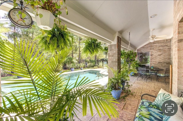 exterior space with outdoor dining space, an outdoor pool, and a ceiling fan