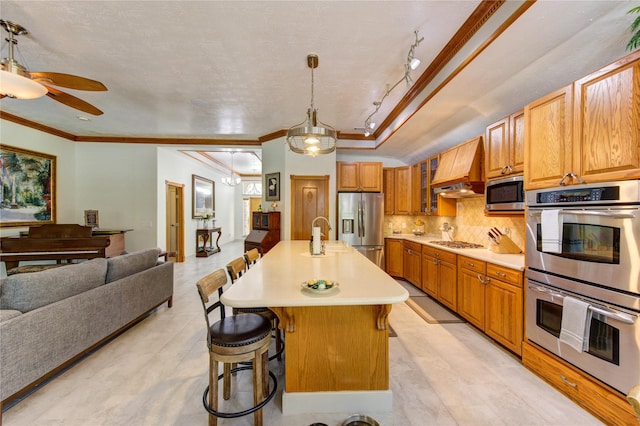 kitchen featuring crown molding, a kitchen breakfast bar, custom exhaust hood, light countertops, and stainless steel appliances