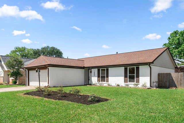 1802 Winston Homestead St, Richmond, TX 77406 - ranch-style house with a front yard, fence, brick siding, an attached garage, and driveway