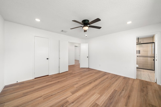 1802 Winston Homestead St, Richmond, TX 77406 - unfurnished bedroom with light wood-type flooring, recessed lighting, ensuite bathroom, a textured ceiling, and visible vents
