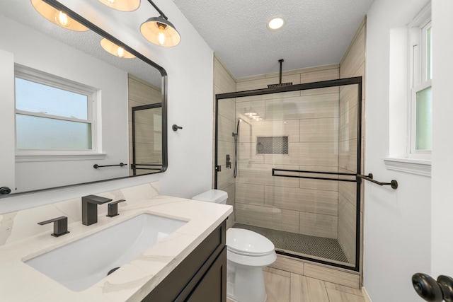 1802 Winston Homestead St, Richmond, TX 77406 - full bathroom featuring toilet, vanity, a textured ceiling, and a stall shower