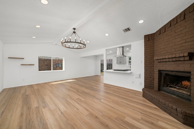 1802 Winston Homestead St, Richmond, TX 77406 - unfurnished living room with a fireplace, visible vents, a textured ceiling, and lofted ceiling with beams