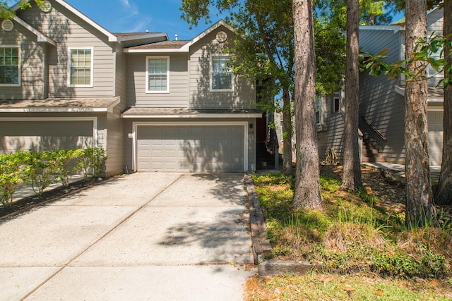 258 Sentry Maple Pl, The Woodlands, TX 77382 - view of front of property featuring an attached garage, driveway, and a shingled roof