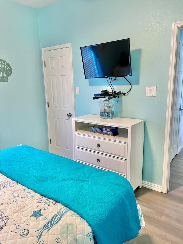 101 Saltgrass Ave, Surfside Beach, TX 77541 - bedroom featuring baseboards and wood finished floors