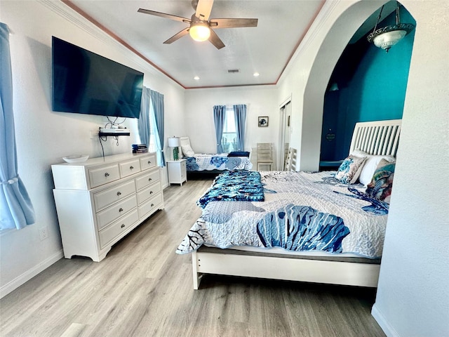 101 Saltgrass Ave, Surfside Beach, TX 77541 - bedroom featuring baseboards, arched walkways, ornamental molding, ceiling fan, and wood finished floors