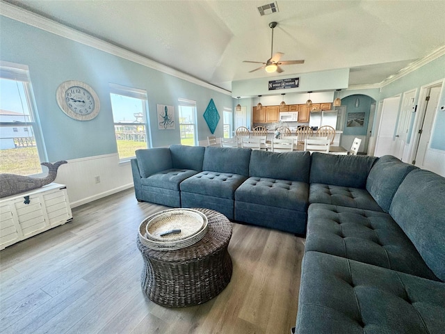 101 Saltgrass Ave, Surfside Beach, TX 77541 - living room with visible vents, a ceiling fan, crown molding, wainscoting, and wood finished floors