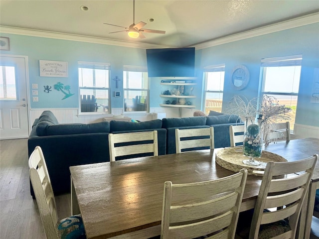 101 Saltgrass Ave, Surfside Beach, TX 77541 - dining area with wood finished floors, crown molding, a wainscoted wall, and ceiling fan