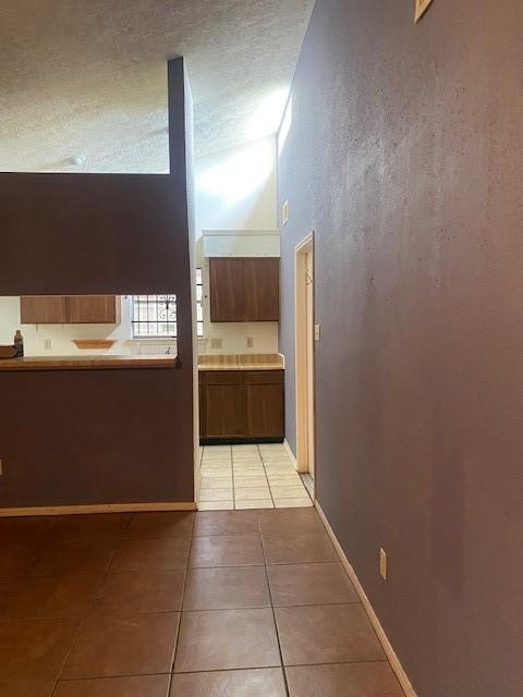 12207 Mckamy Dr, Houston, TX 77067 - corridor featuring light tile patterned floors and baseboards