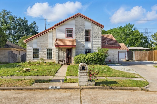 6022 Downwood Forest Dr, Houston, TX 77088 - traditional home with a tiled roof, concrete driveway, and fence