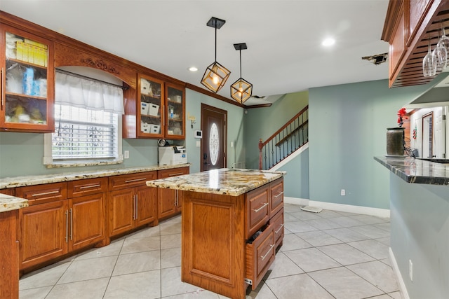 6022 Downwood Forest Dr, Houston, TX 77088 - kitchen featuring brown cabinets, decorative light fixtures, and light stone countertops