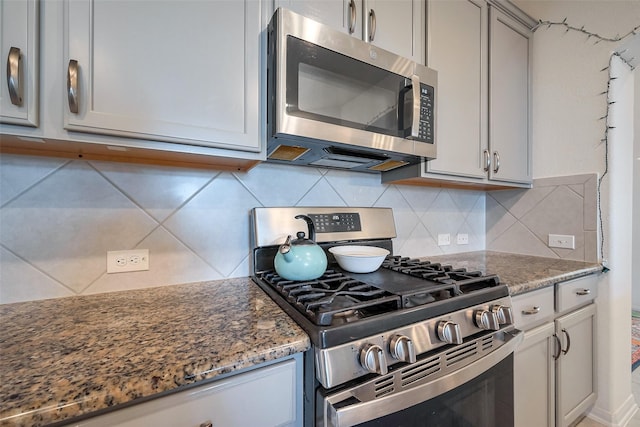 5819 Southern Rose Ln, Rosenberg, TX 77469 - kitchen featuring tasteful backsplash, stone counters, gray cabinetry, and stainless steel appliances