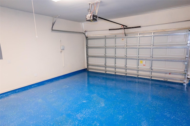 garage featuring a garage door opener and baseboards