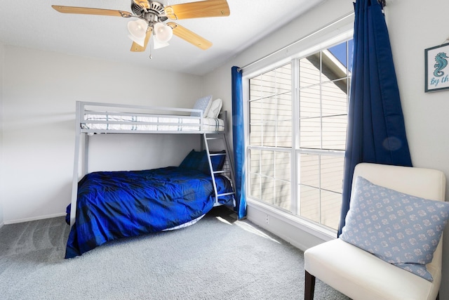 carpeted bedroom with baseboards and ceiling fan