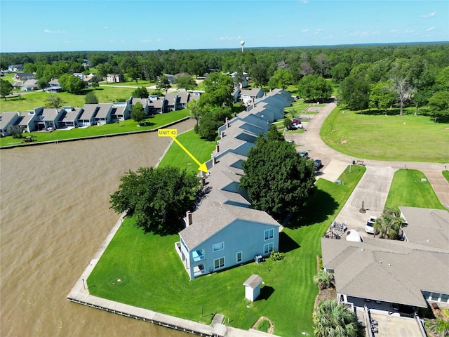 drone / aerial view featuring a residential view and a view of trees
