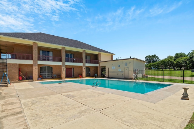 view of swimming pool with a fenced in pool, fence, and a patio area