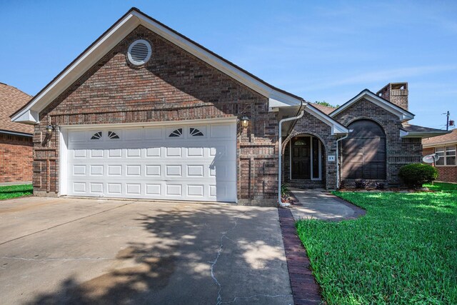 39 Alexander Ct, Angleton, TX 77515 - view of front of property with brick siding, driveway, an attached garage, and a front yard