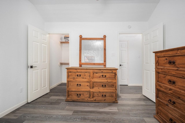 39 Alexander Ct, Angleton, TX 77515 - bedroom with dark wood-style flooring, a spacious closet, baseboards, and vaulted ceiling