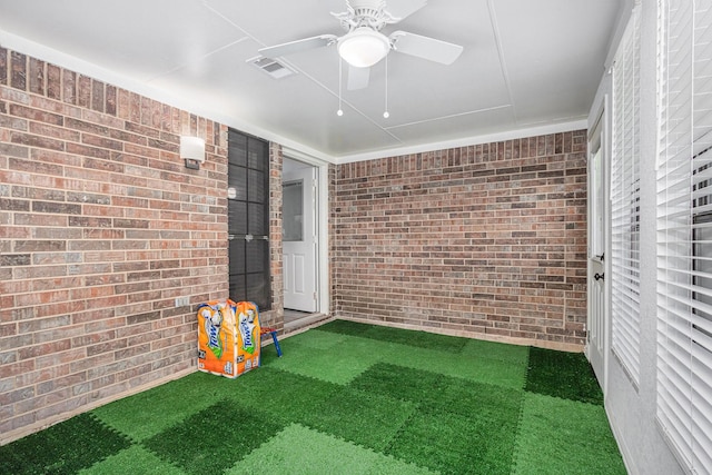 39 Alexander Ct, Angleton, TX 77515 - rec room featuring brick wall, carpet flooring, and a ceiling fan