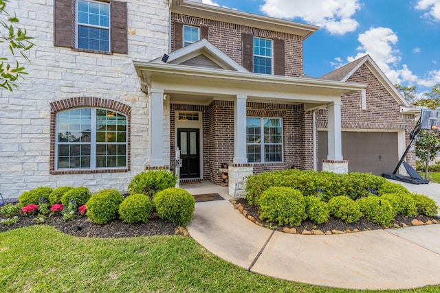 doorway to property with brick siding, an attached garage, and stone siding