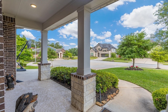 view of patio / terrace with a residential view and covered porch