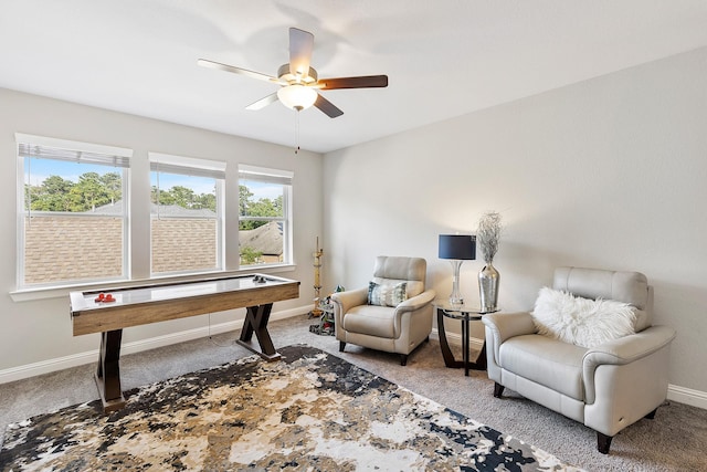 sitting room featuring ceiling fan, baseboards, and carpet floors