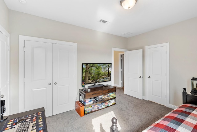 bedroom with carpet, visible vents, and a closet