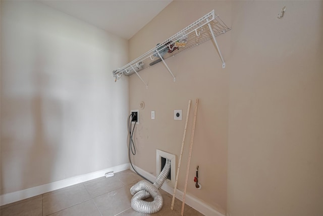 washroom featuring hookup for an electric dryer, laundry area, hookup for a gas dryer, tile patterned floors, and baseboards