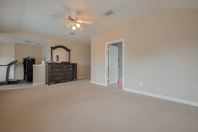 unfurnished bedroom with carpet floors, baseboards, visible vents, and lofted ceiling