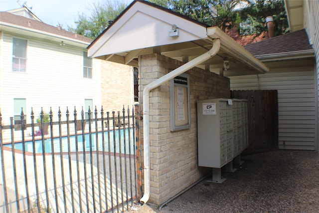 2300 Augusta Dr Unit 36, Houston, TX 77057 - exterior space with a community pool, stone siding, and fence