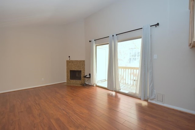 2300 Augusta Dr Unit 36, Houston, TX 77057 - unfurnished living room with a fireplace with flush hearth, wood finished floors, and baseboards