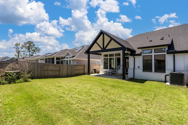 16958 Chapel Knox Dr, Humble, TX 77346 - rear view of house with central AC, a lawn, a patio, fence, and brick siding