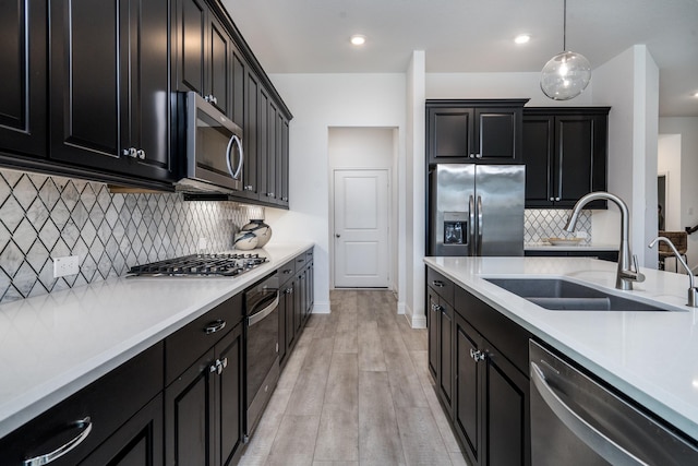 16958 Chapel Knox Dr, Humble, TX 77346 - kitchen with stainless steel appliances, dark cabinets, light countertops, and a sink