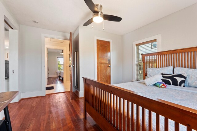 2216 Grover Ave, Galveston, TX 77551 - bedroom featuring attic access, wood-type flooring, baseboards, and a ceiling fan