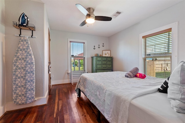2216 Grover Ave, Galveston, TX 77551 - bedroom with wood-type flooring, baseboards, and a ceiling fan