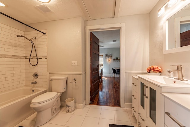 2216 Grover Ave, Galveston, TX 77551 - bathroom featuring wainscoting, toilet, tile patterned floors,  shower combination, and vanity
