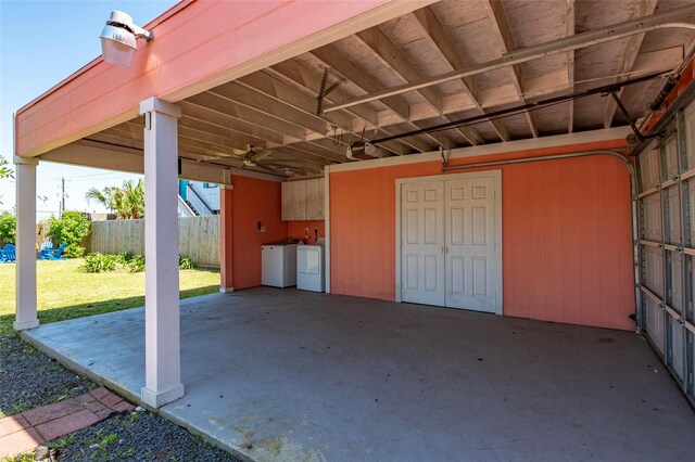 2216 Grover Ave, Galveston, TX 77551 - view of patio / terrace featuring washer and dryer, a carport, and fence