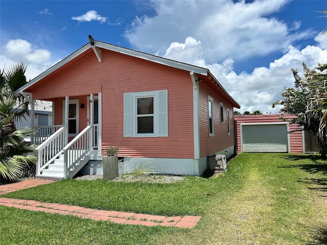 2216 Grover Ave, Galveston, TX 77551 - view of front facade featuring a front lawn, an outdoor structure, and a porch