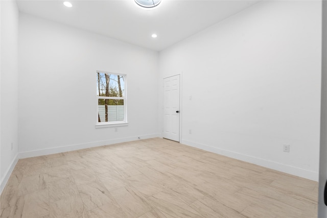 empty room with baseboards and recessed lighting