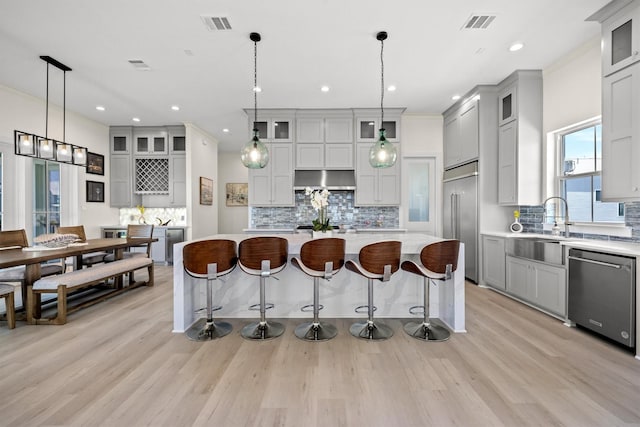 11370 Beachside, Galveston, TX 77554 - kitchen with a breakfast bar, visible vents, light countertops, and appliances with stainless steel finishes