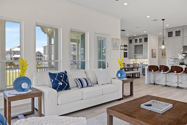 11370 Beachside, Galveston, TX 77554 - living area featuring recessed lighting, visible vents, light wood-type flooring, and ornamental molding