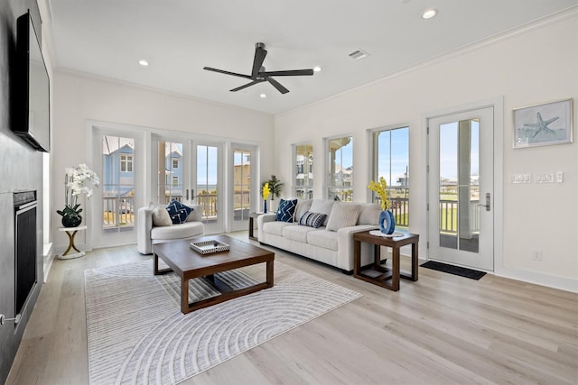 11370 Beachside, Galveston, TX 77554 - living room featuring light wood-style floors, visible vents, a ceiling fan, and crown molding