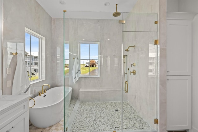 11370 Beachside, Galveston, TX 77554 - bathroom featuring a freestanding tub, vanity, tile walls, and a stall shower