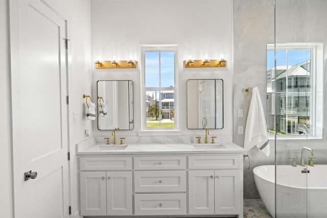 11370 Beachside, Galveston, TX 77554 - bathroom with double vanity, a sink, and a healthy amount of sunlight