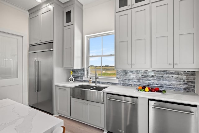 11370 Beachside, Galveston, TX 77554 - kitchen featuring glass insert cabinets, a sink, crown molding, stainless steel appliances, and backsplash