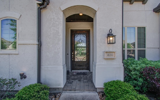 doorway to property with stucco siding