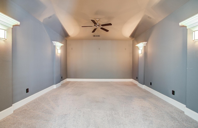 carpeted empty room featuring ornate columns, baseboards, a ceiling fan, and visible vents